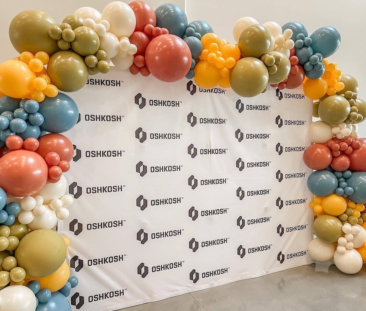 Corporate balloon setup on a step and repeat banner