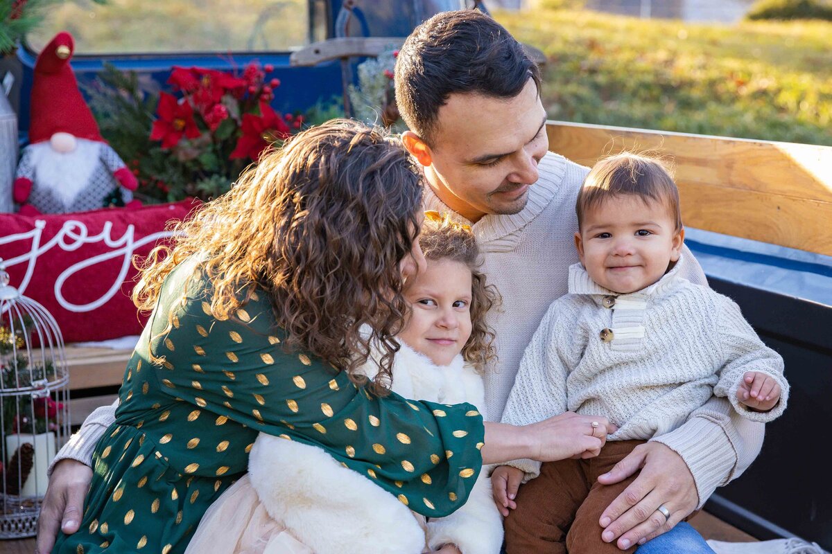 family interacting on vintage christmas truck on a christmas tree farm in Litchfield Connecticut