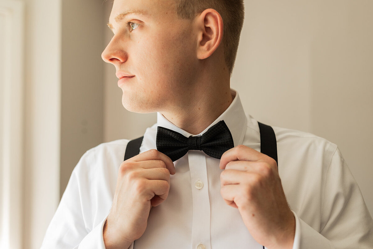 groom finishes getting ready