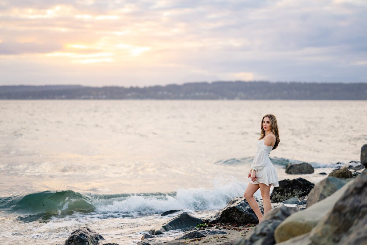 seattle high school senior puget sound portrait in the water at sunset golden hour in a white dress