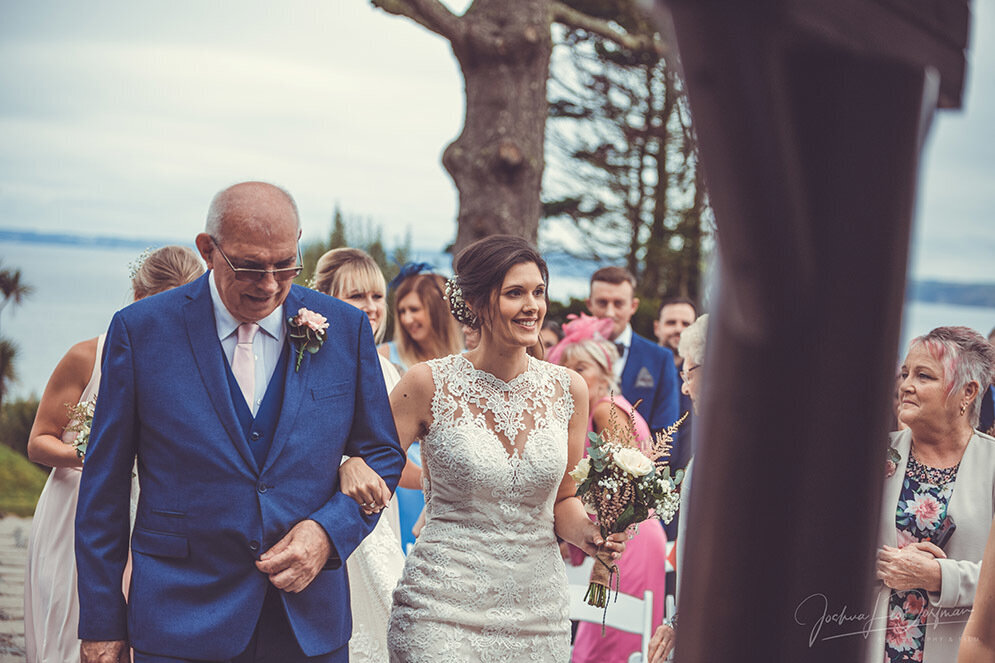 A bride and the father of the bride walking down the aisle