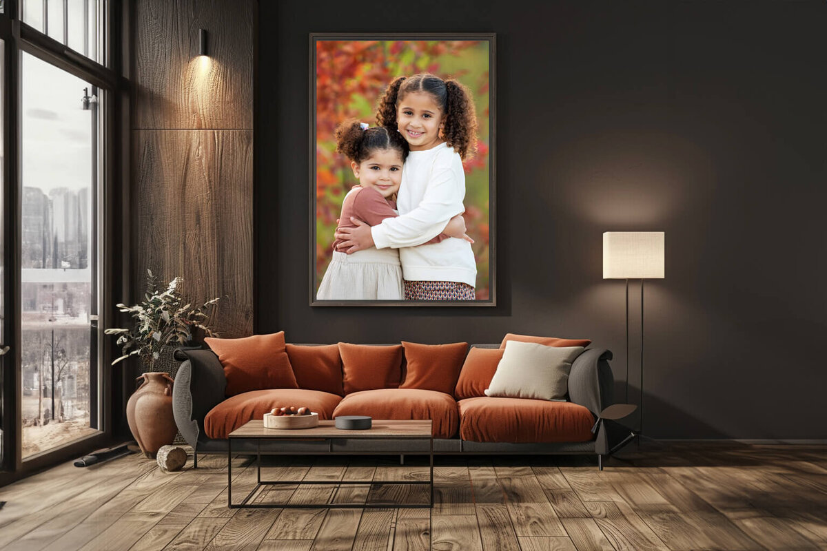 Living room with a framed photo of two sisters hugging outside at their fall family photography session in Burlington, ON
