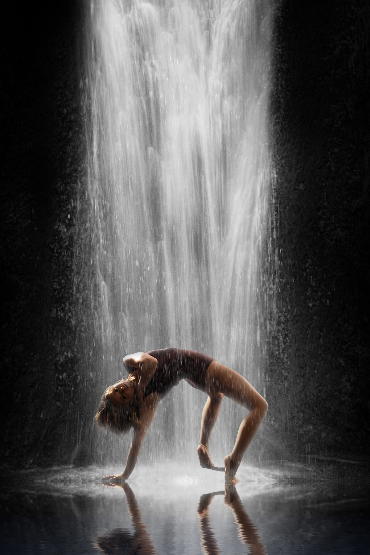A modern dance student from Germantown High School poses in a backbend with an A.I. waterfall cascading upon her for this artistic portrait in her senior year.