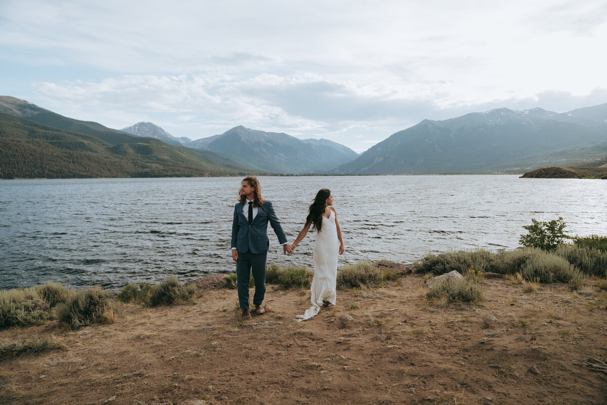 A couple elopes on the shores of Twin Lakes in Colorado during the summer.