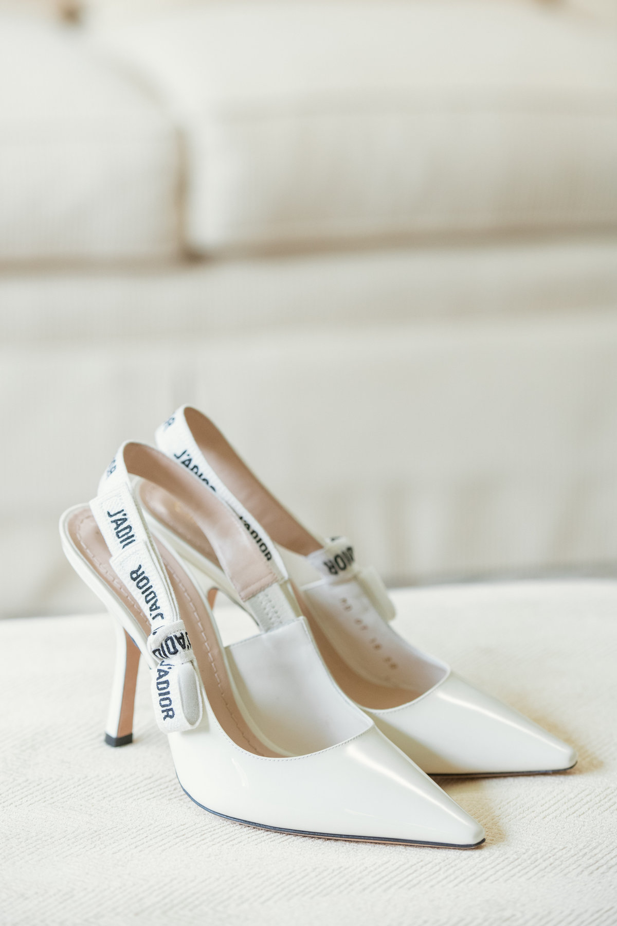 white on white photo of bridal shoes from wedding at The Muttontown Club