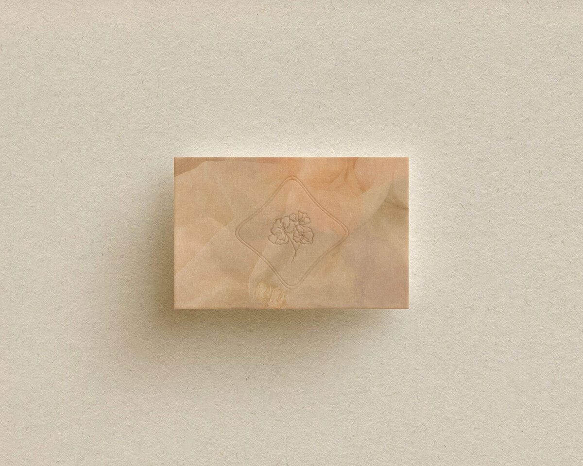 a pink textured business card with a floral design