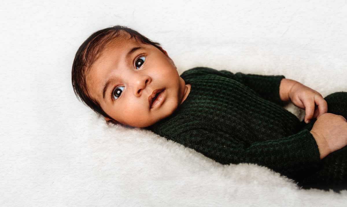 newborn in green