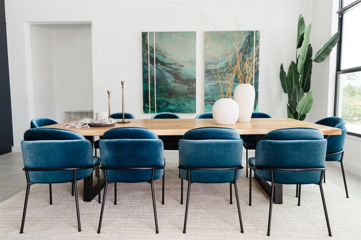 modern dining room complete with an oak table, velvet dining chairs and abstract artwork