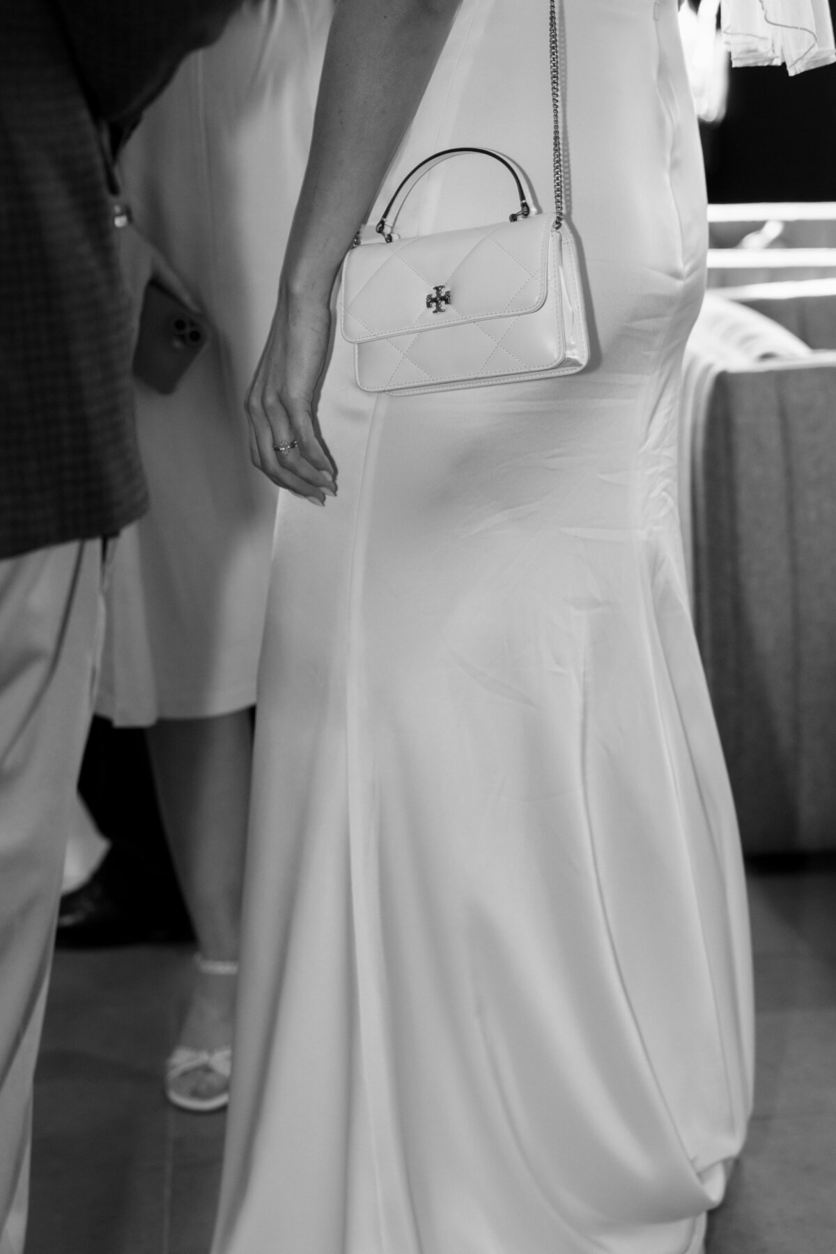 wedding guest carrying her purse