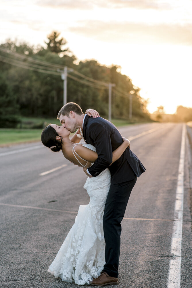 bride and groom kissing on the street