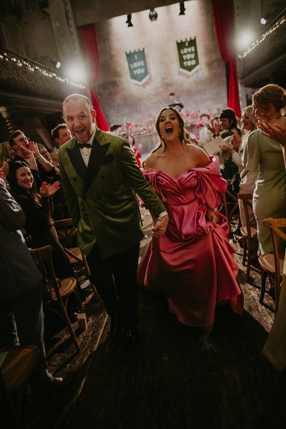 Bride and groom scream as they exit their wedding ceremony at Wilton's Music Hall to a huge applause. 