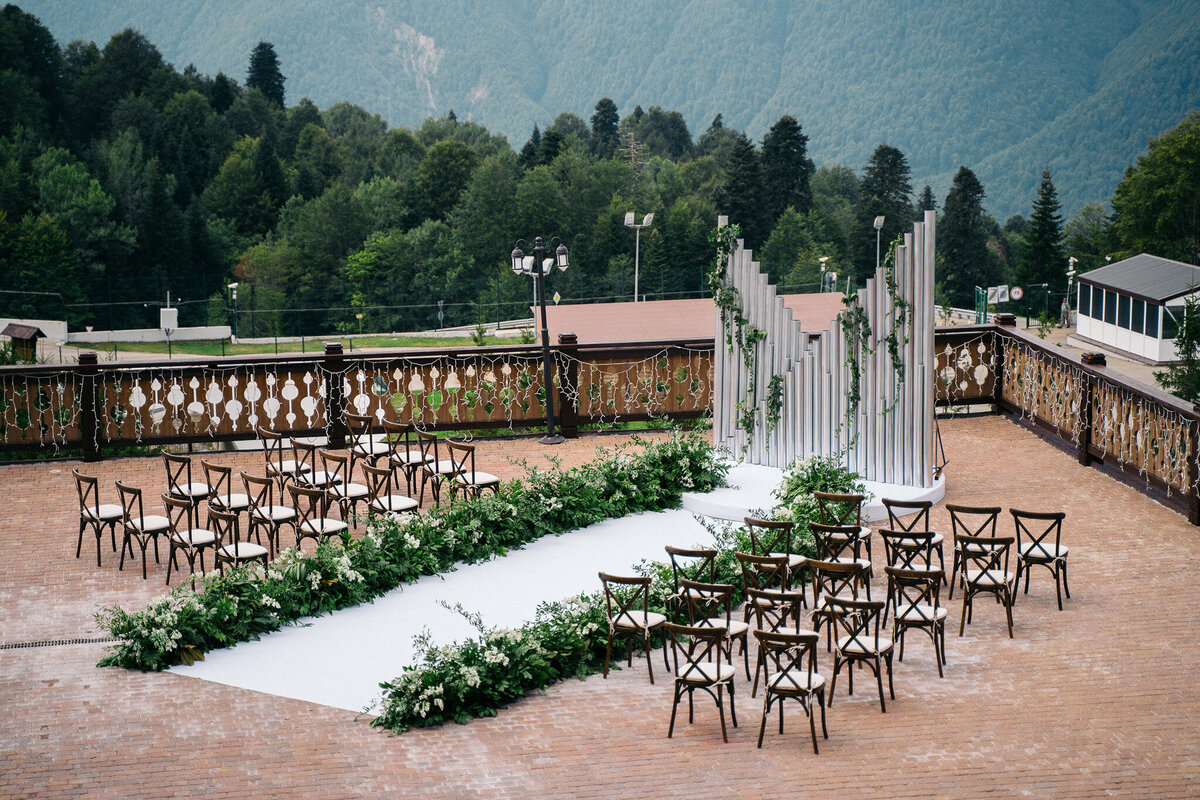 Ceremony setup at Tuscan luxury villa with mountain views and floral accents