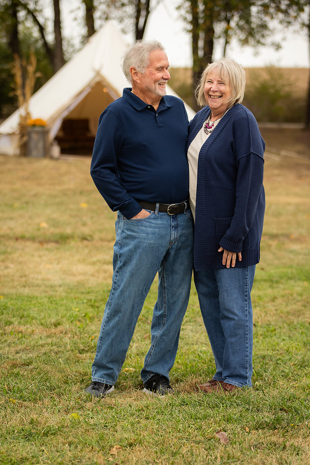 man looking at woman as she laughs and looks at the camera