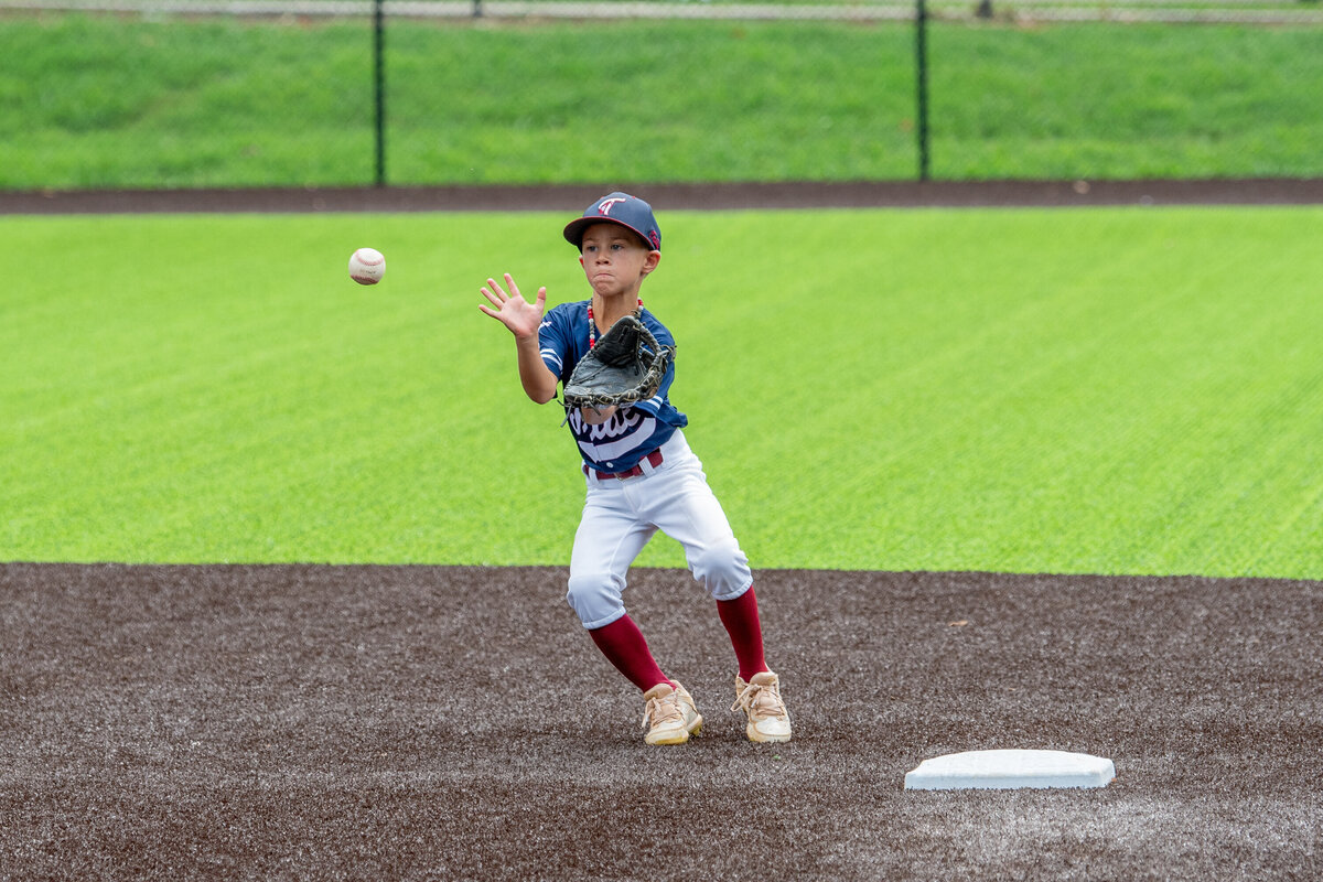 a baseball player gets ready to catch a ball