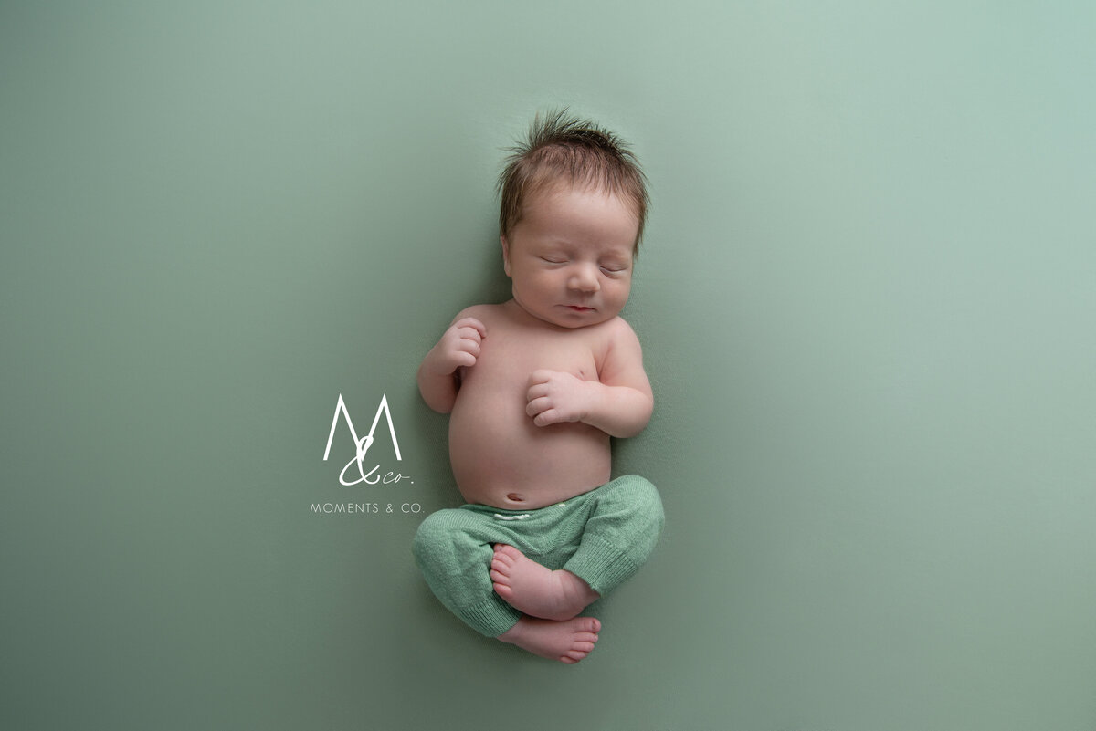 Green-Baby-Boy-with-newborn-pants-and-a-lot-of-hair-image