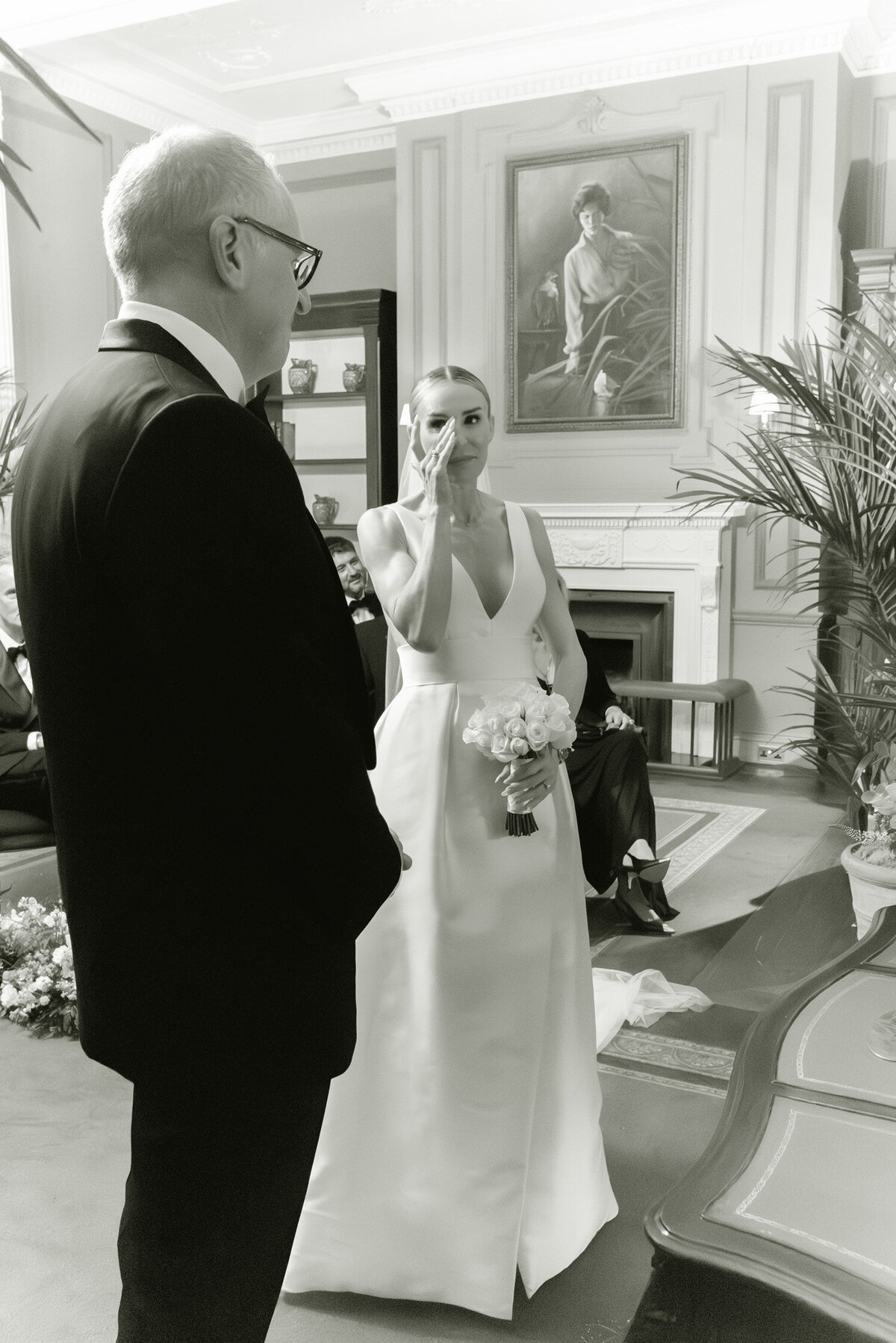 A bride wipes away a tear during her Gleneagles wedding ceremony. Image by Scotland wedding photographer, Jill Cherry Porter.