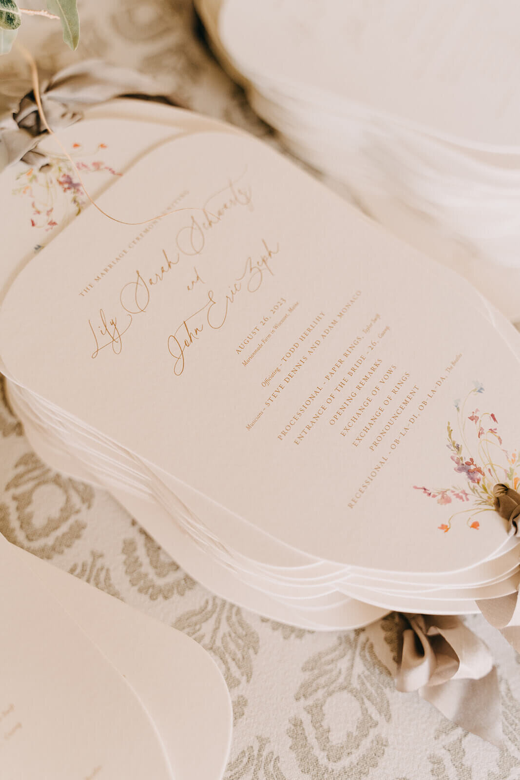 53.poeme-wedding-ceremony-programs-taupe-ribbon-floral-design.