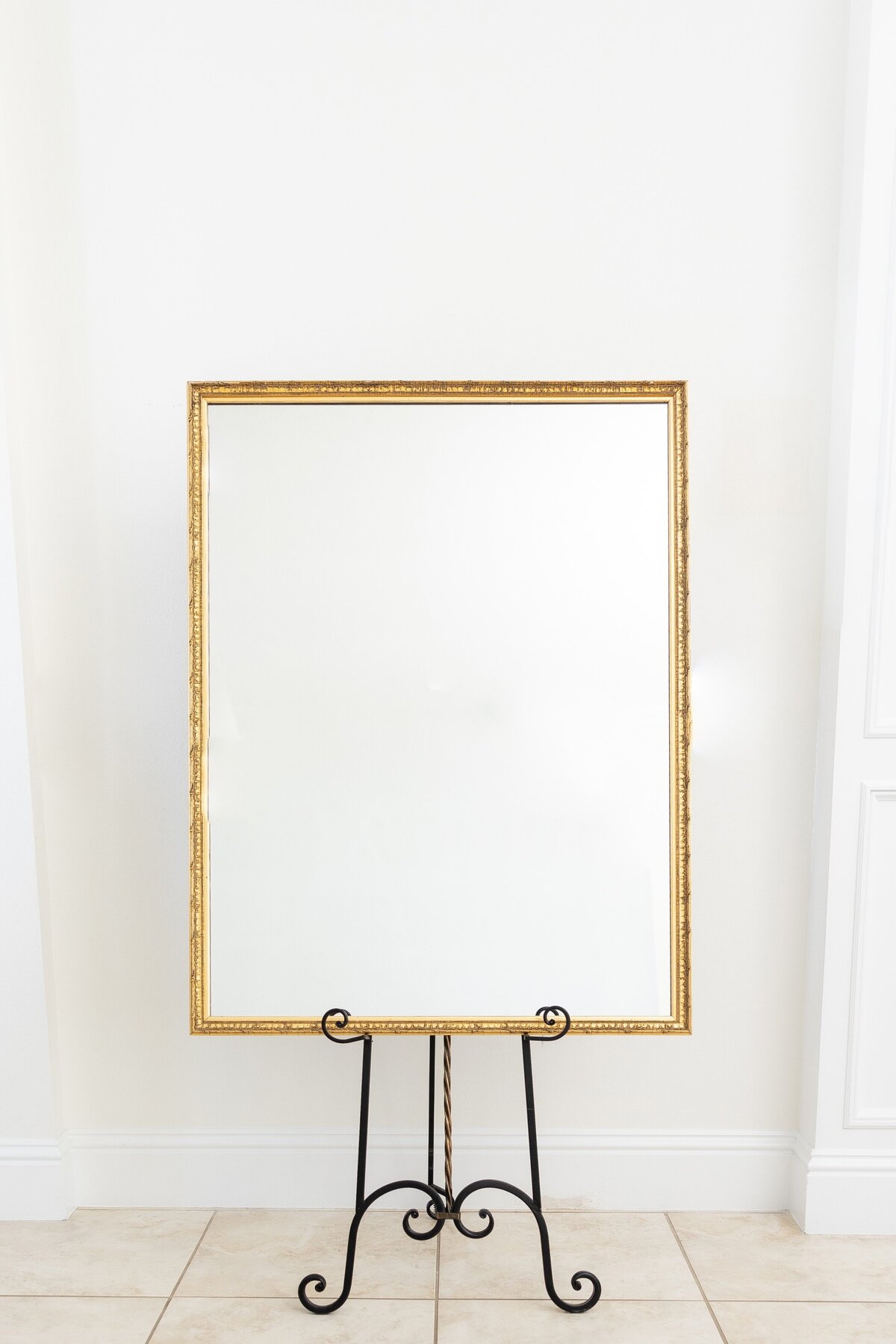 Large gold mirror with ornate border 