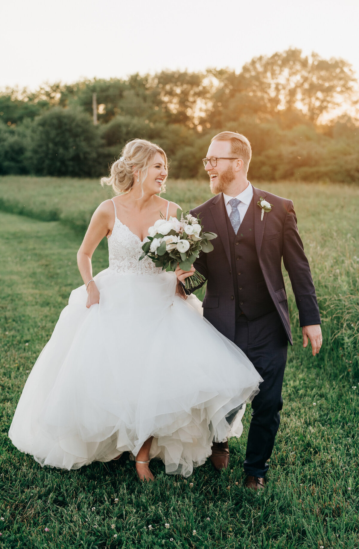 Candid portraits of bride and groom enjoying the sunset at their Willow Creek Barn wedding by Nova Markina Photography
