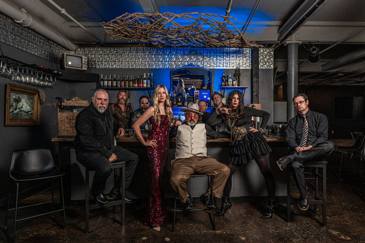 A group of people posing a bar together 