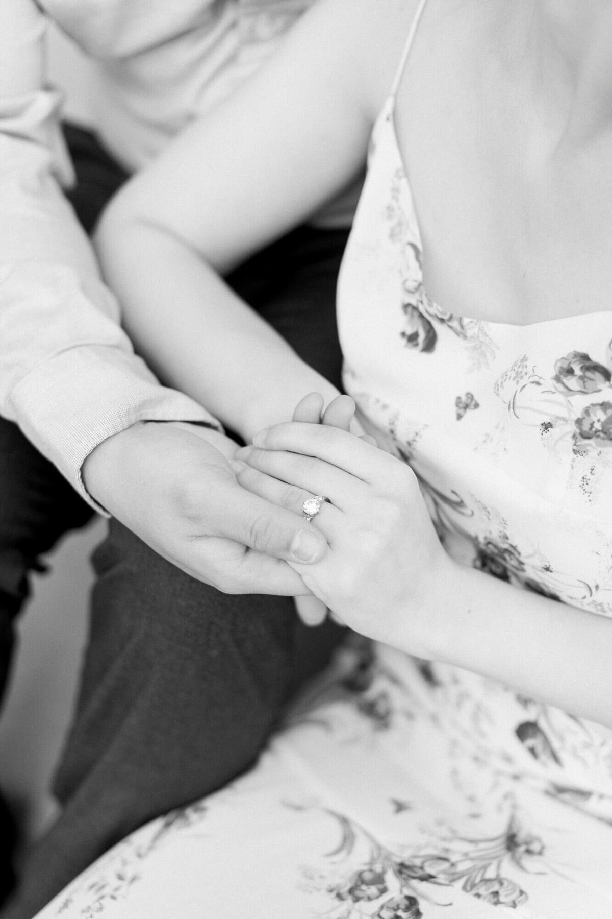 black and white photo of close up engagement ring