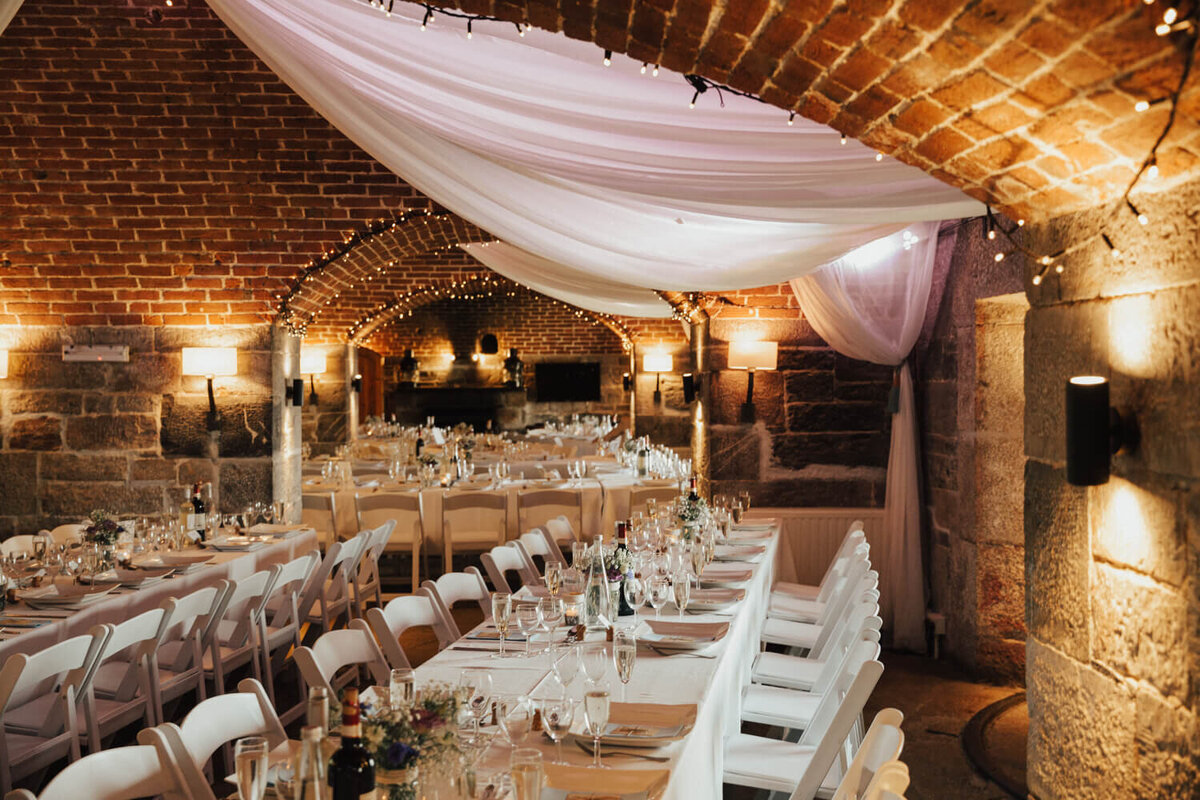 A banquet hall with tables set up for a formal function