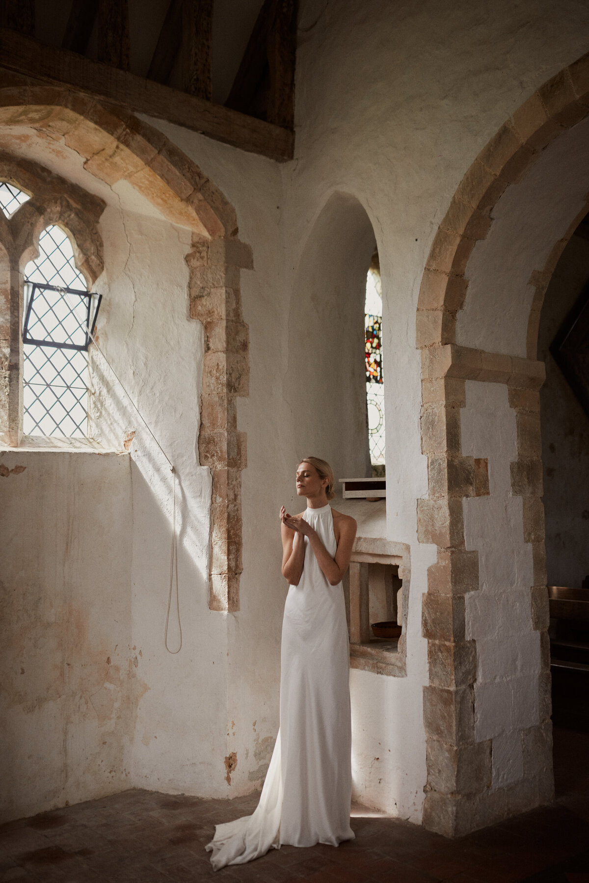 Sleeveless silk high neck wedding dress by British designer
