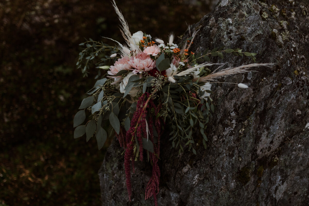 floral bouquet sitting on rocks