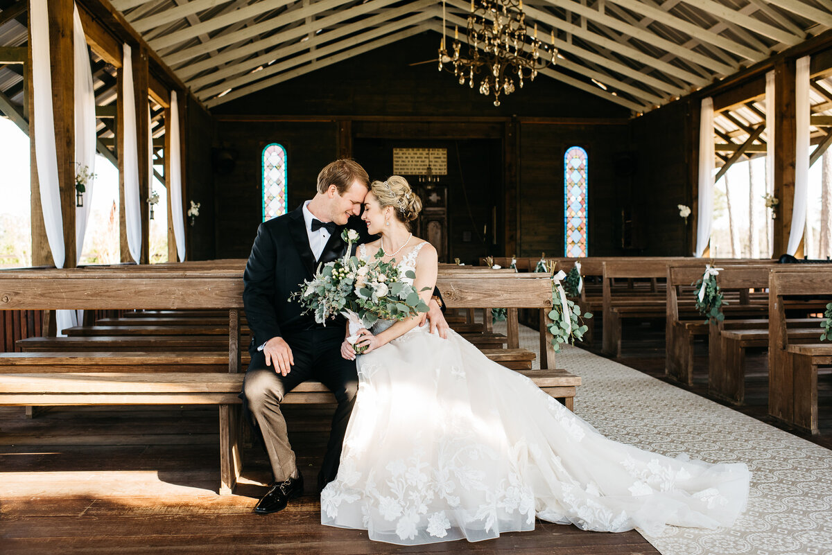 Pine Knoll Farms wedding - couple sitting in pews after ceremony