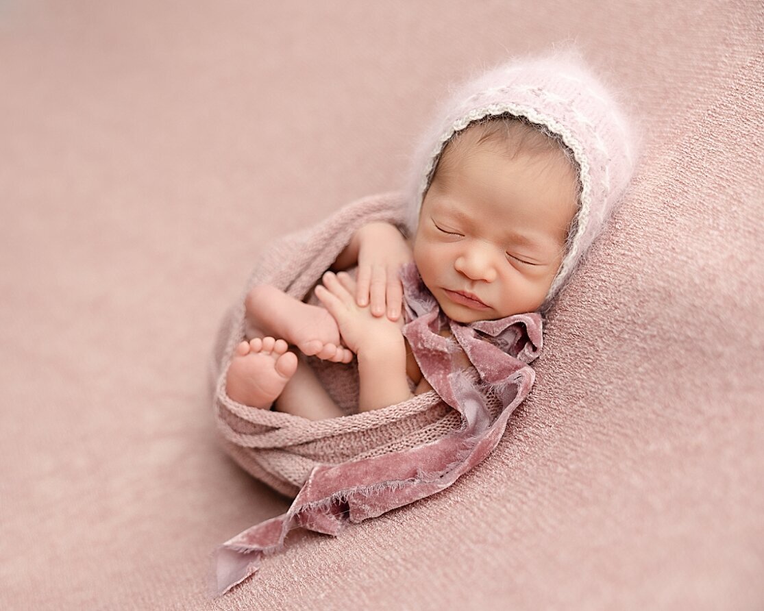 wrapped up baby in pink for newborn pictures in hillsboro oregon