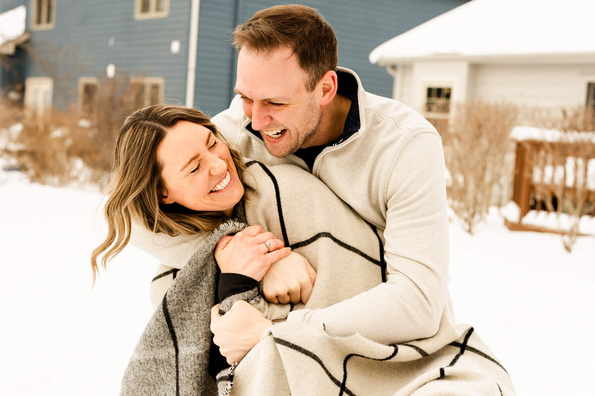 Couple goofing around in the snow during a photography session in Naperville, IL.