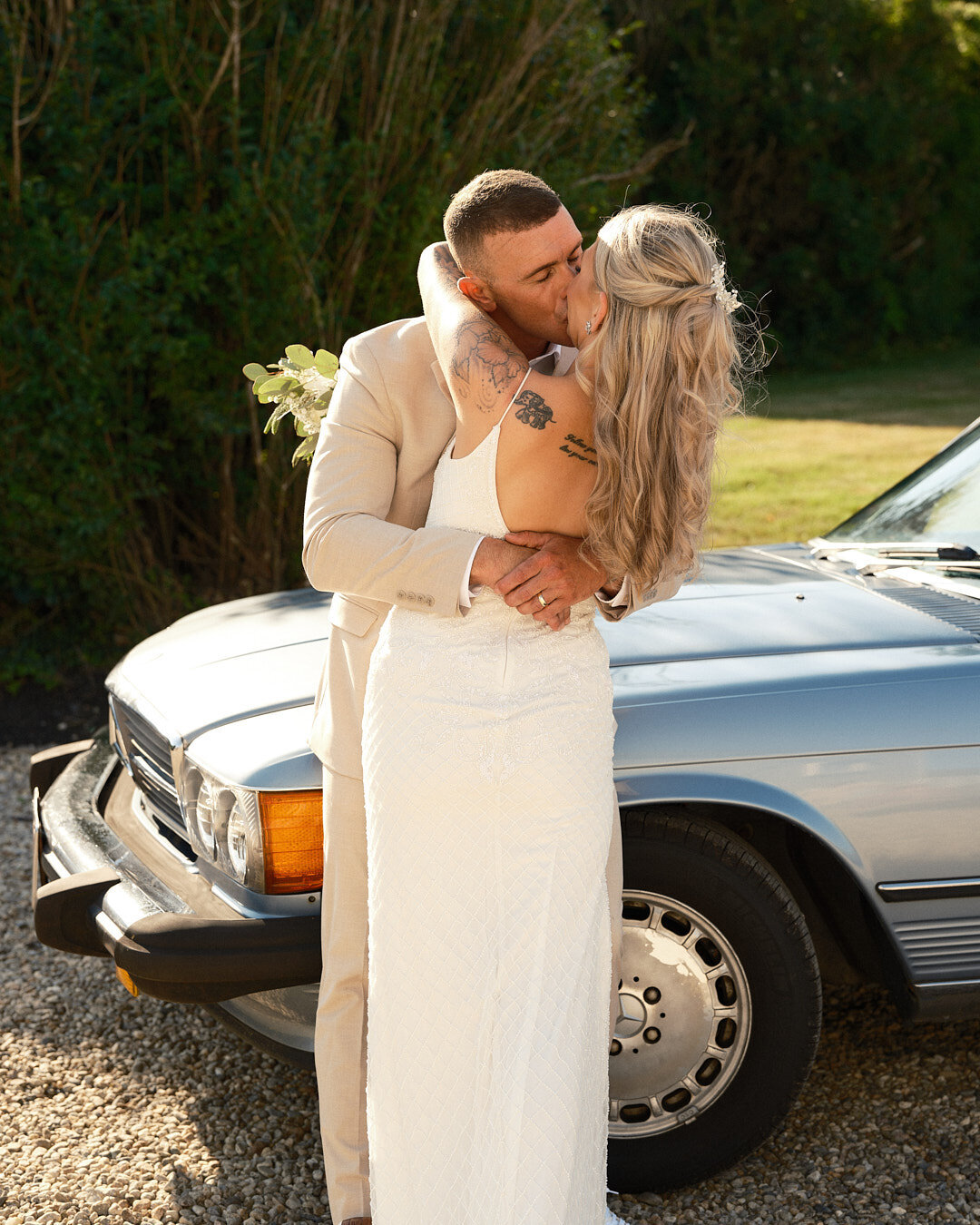 wedding couple in front of a classic car