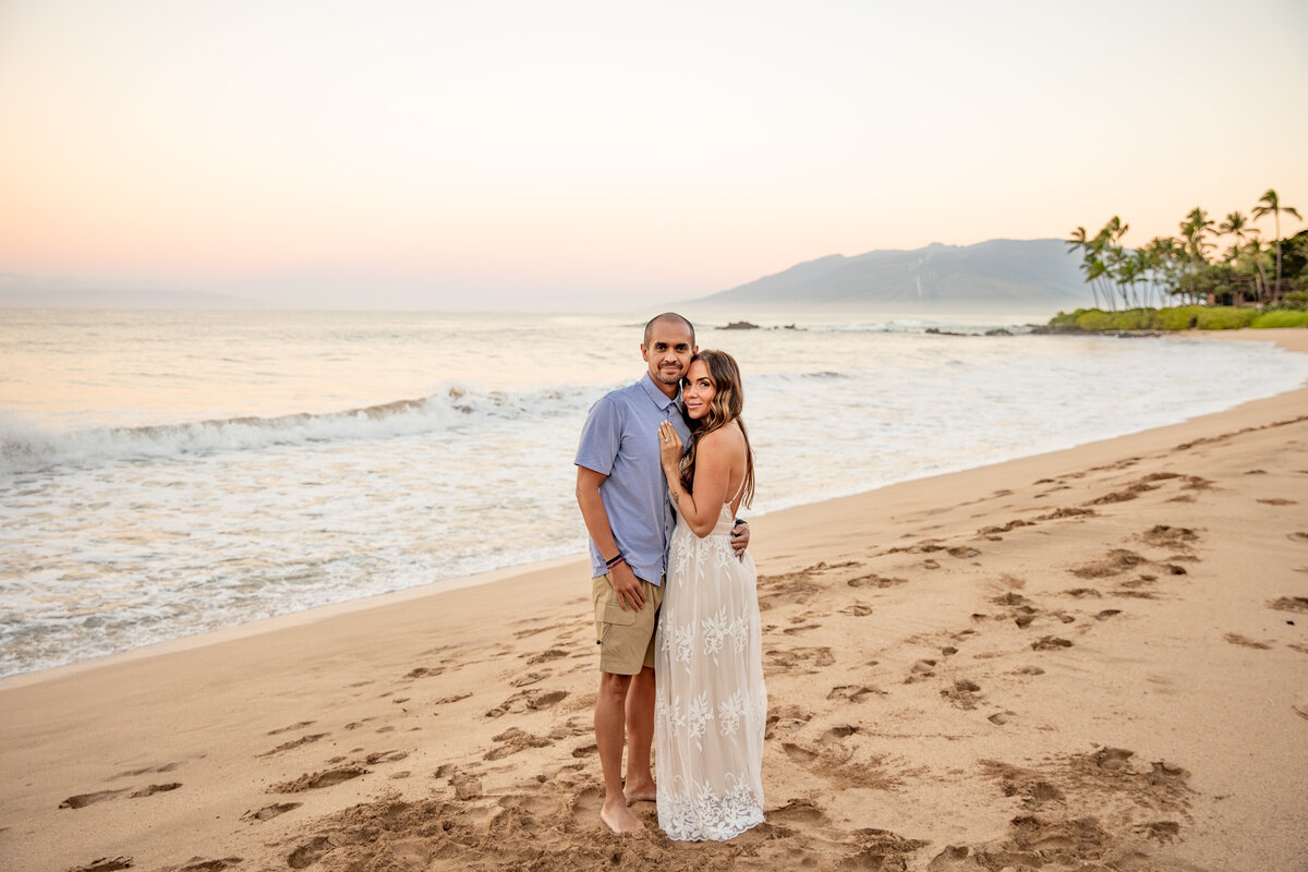 Maui Family Photographers capture couple hugging on beach at sunset