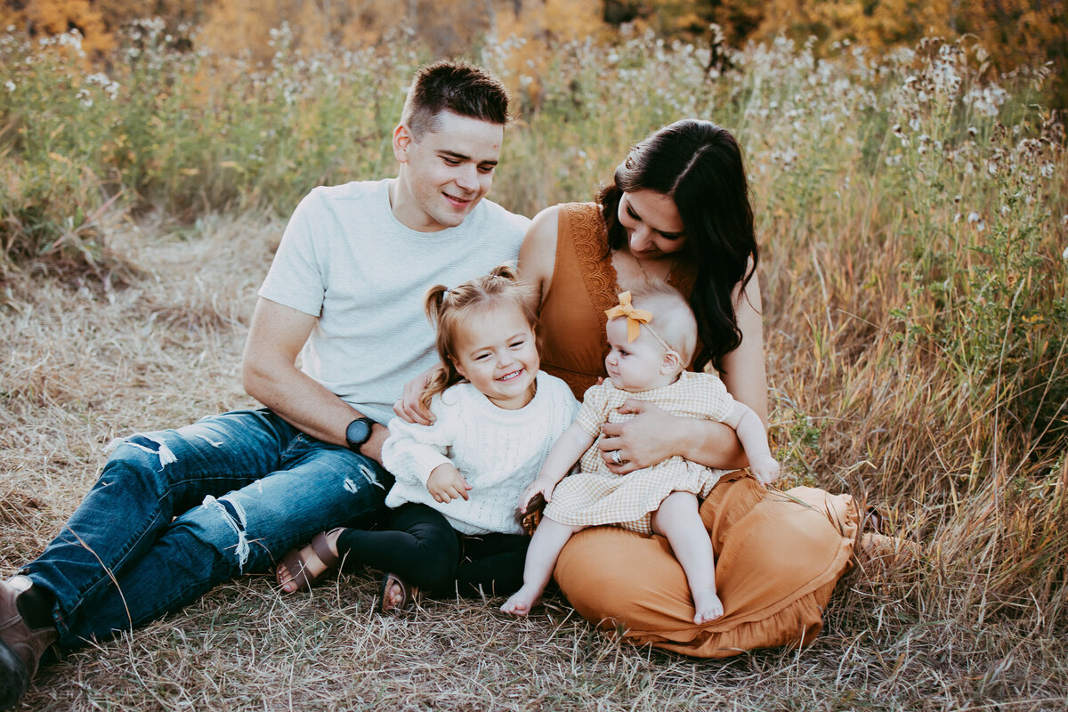 family sitting in a field