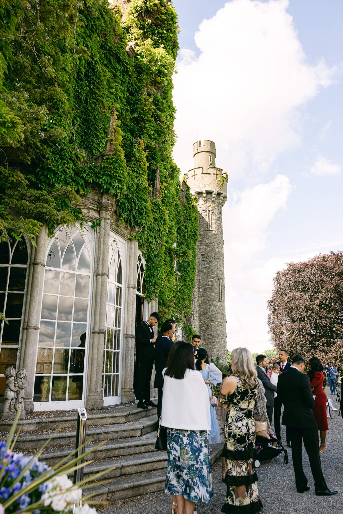 A wedding photo of guests during cocktail hour at Luttrellstown Castle in Ireland