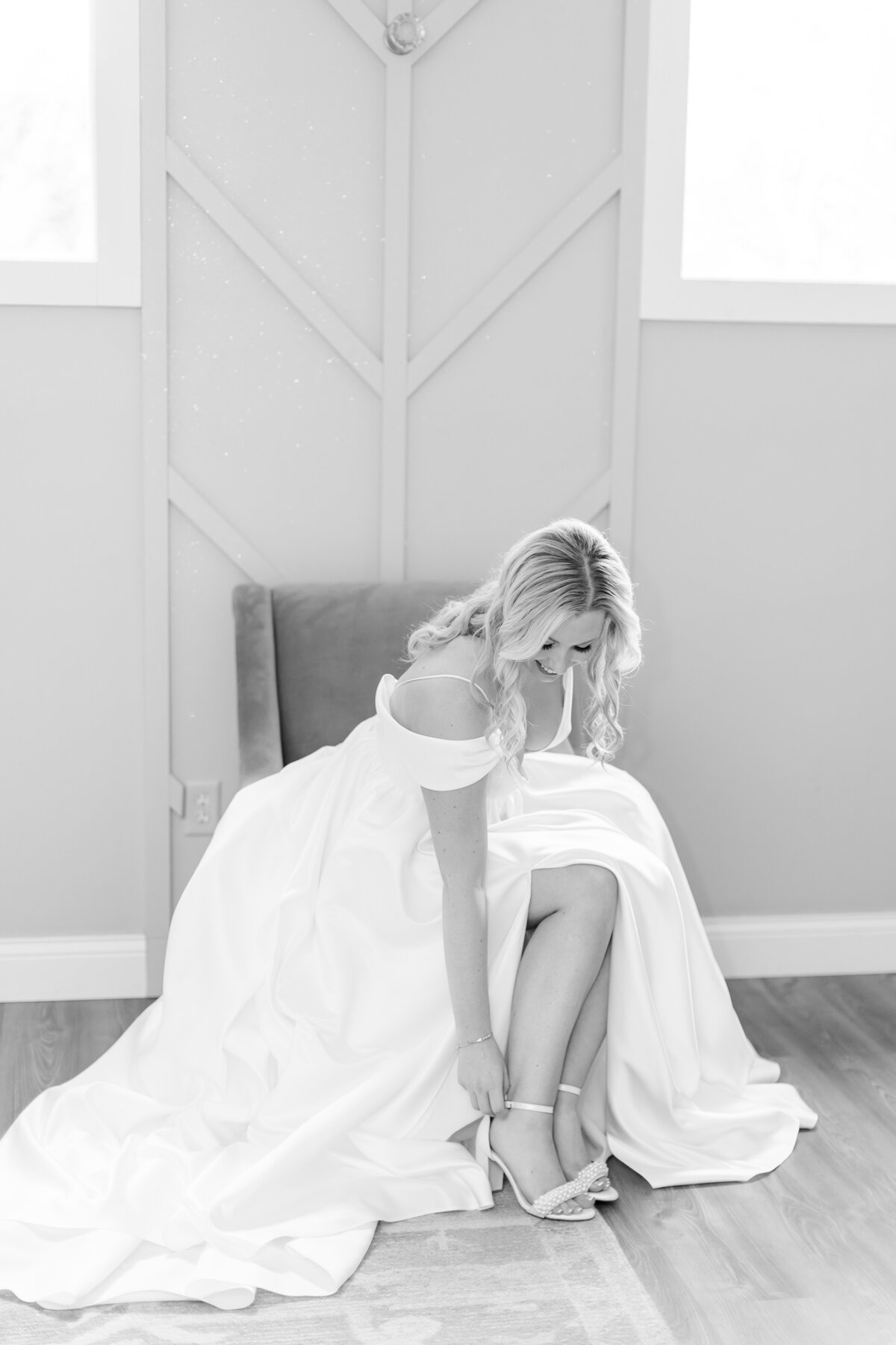 bride putting her shoes on by orlando wedding photographer
