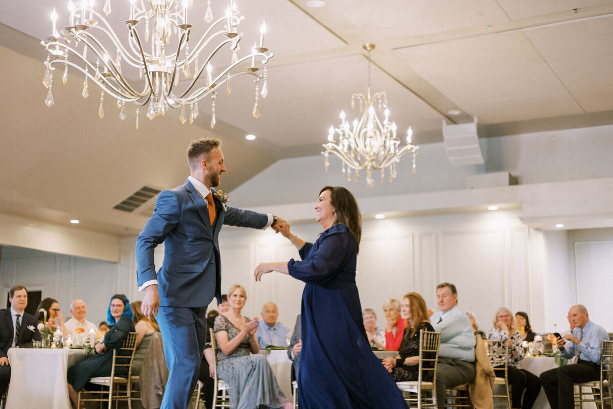 father-mother-dance-with-guests-looking-on