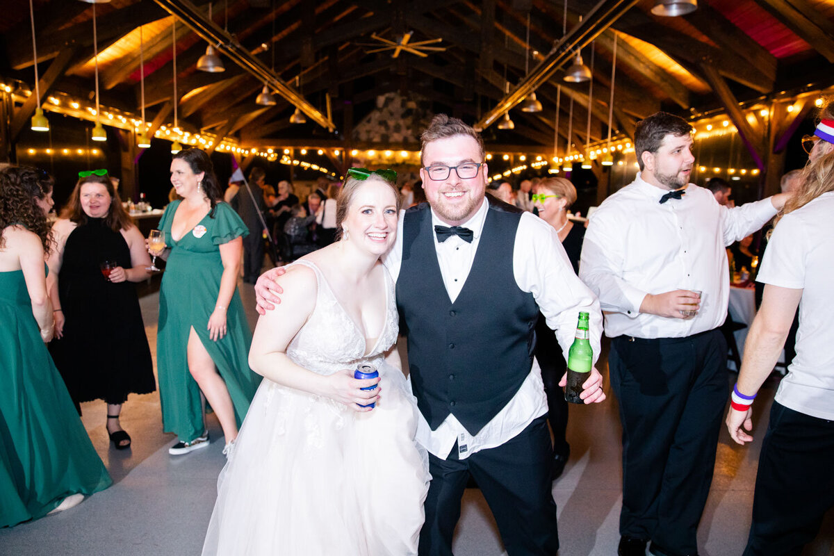 Bride and groom holding their own beer