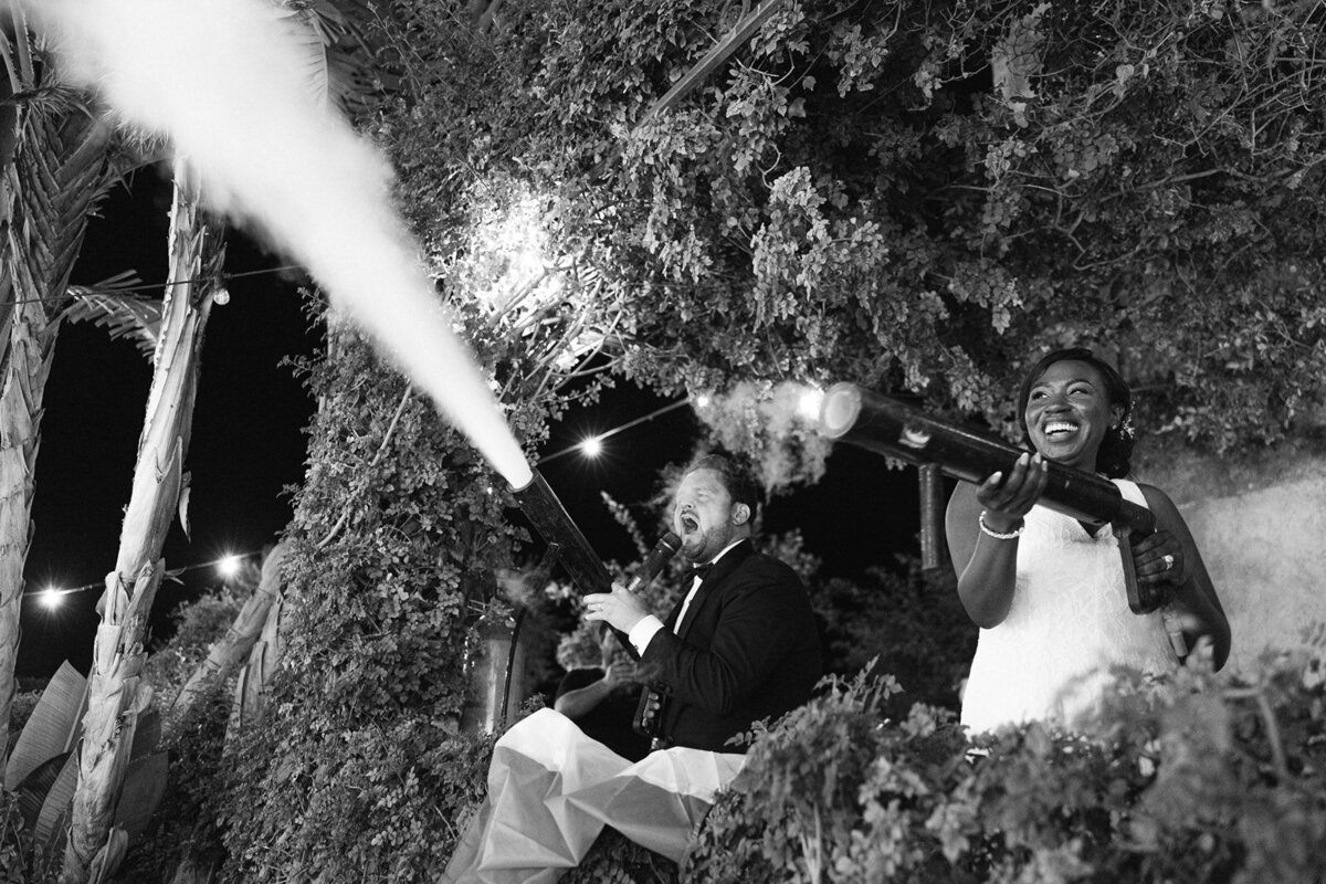 a bride holding on to her groom's arm