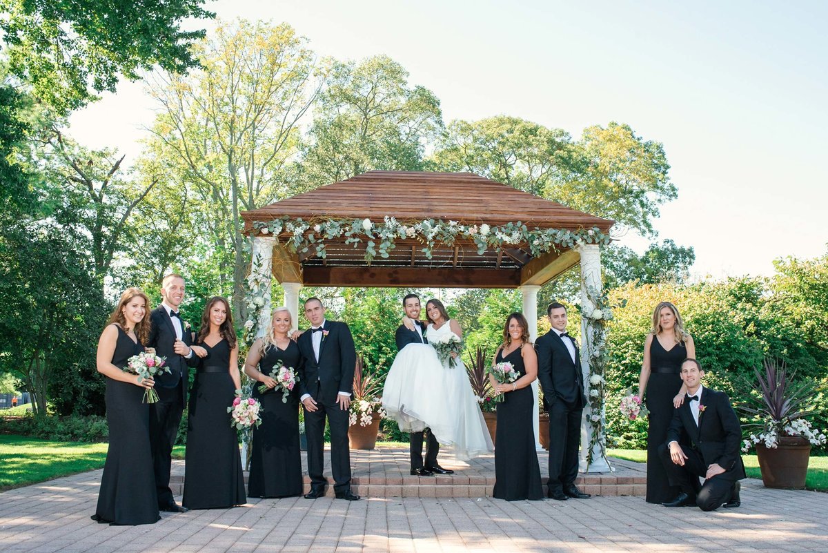 Bridal party in front of outdoor reception area at Stonebridge Country Club