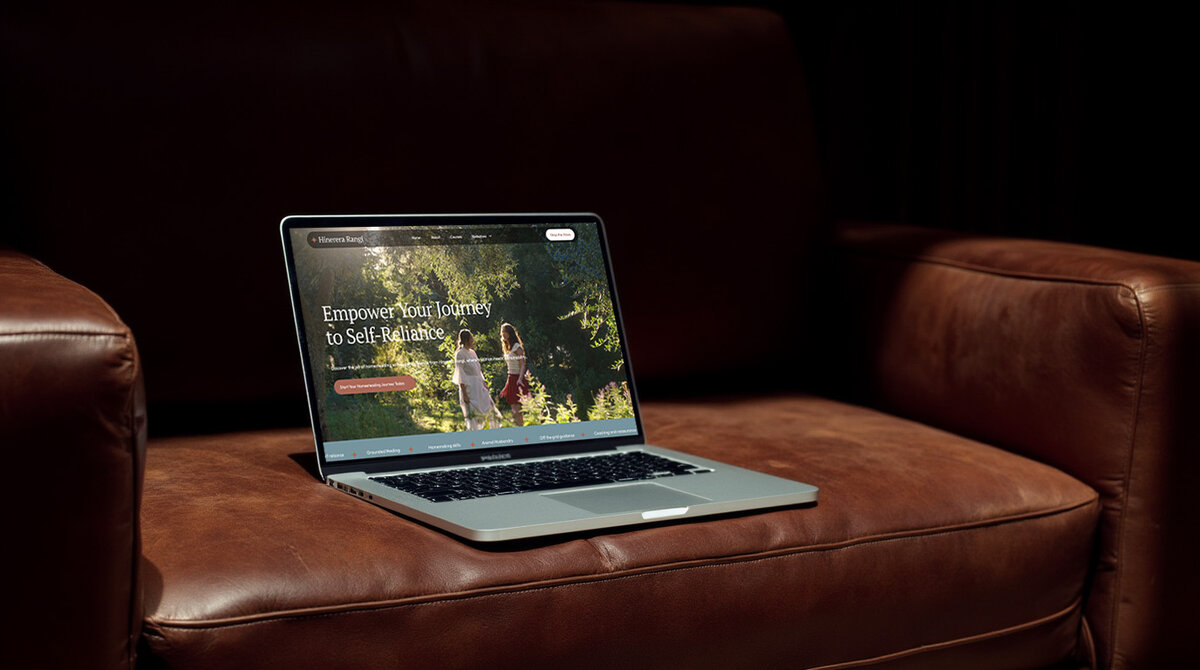 a_mockup_scene_of_a_macbook_sitting_open_on_a_leather_couch_the_background_is_black_and_has_soft_na_oxjecbzgeivwxmol10oc_0