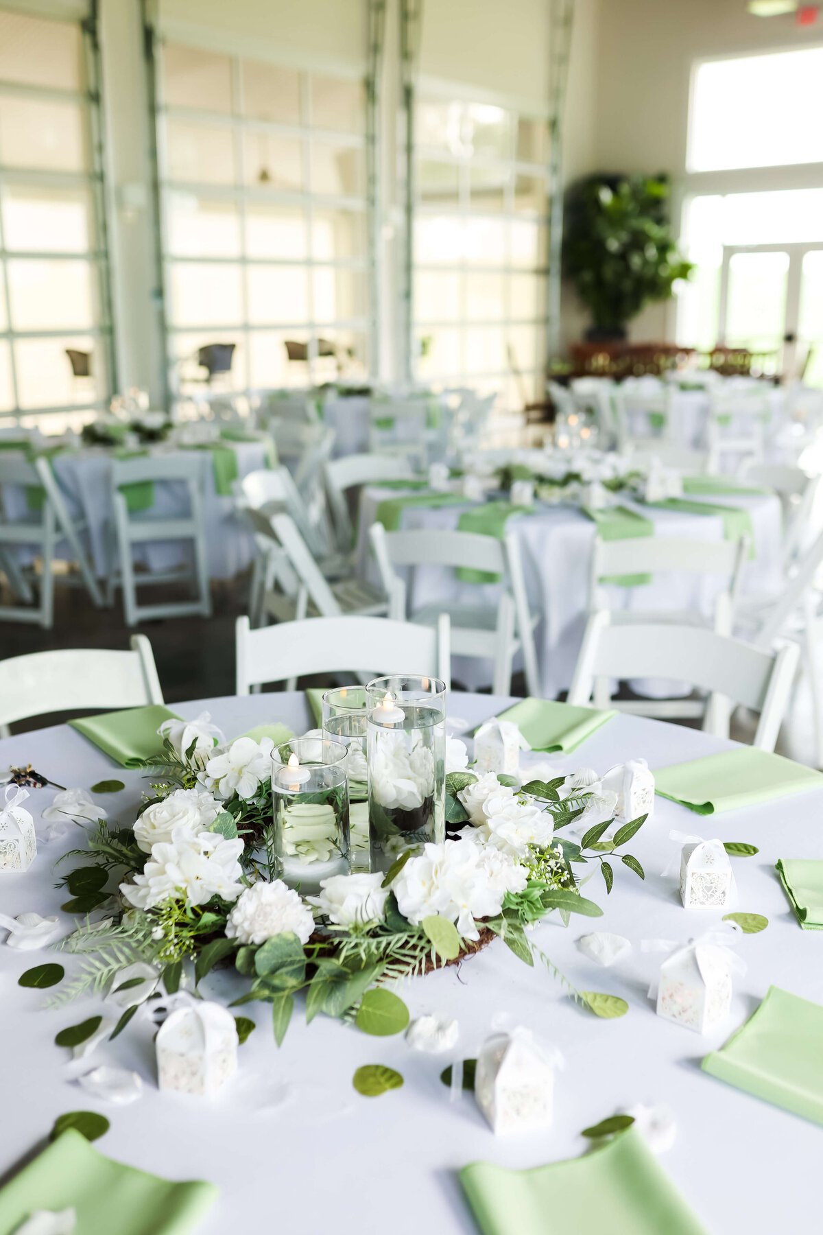 wedding reception table with florals centerpiece and green napkins at Ruby Cora wedding venue in Adams,,TN