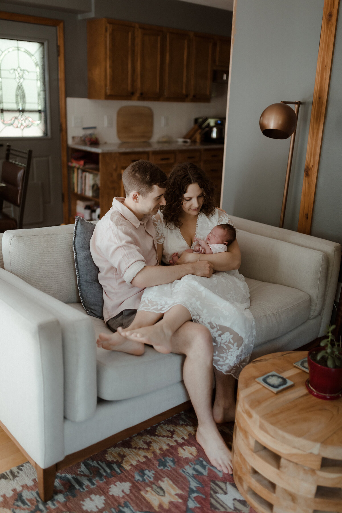 Family on couch with newborn