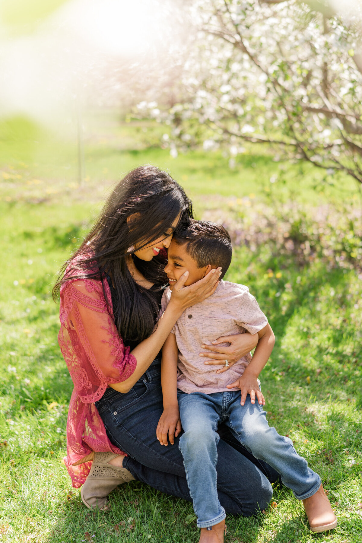 a bright colorful photo of mother and son during a cherry blossom session