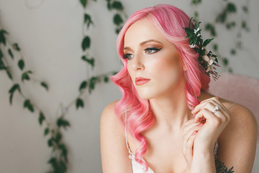 Bride with long, newly styled pink hair  looks into distance