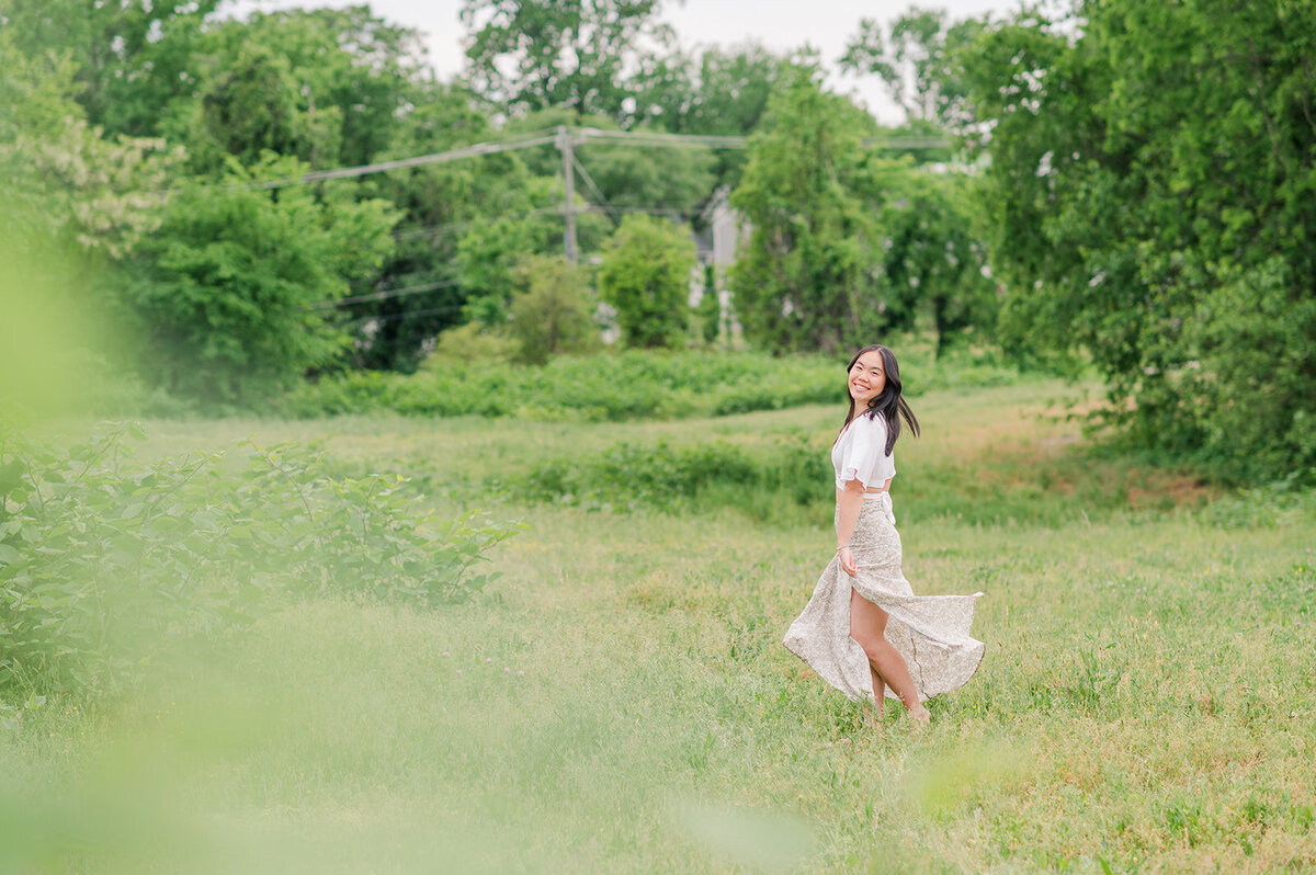 vibrant photo of a girl in a dress standing in a field