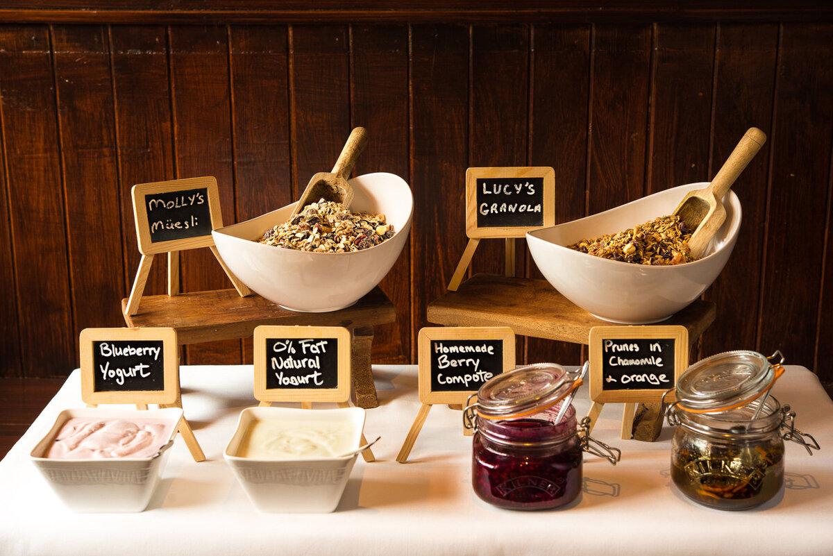 hotel breakfast display of muesli , yoghurt and jam