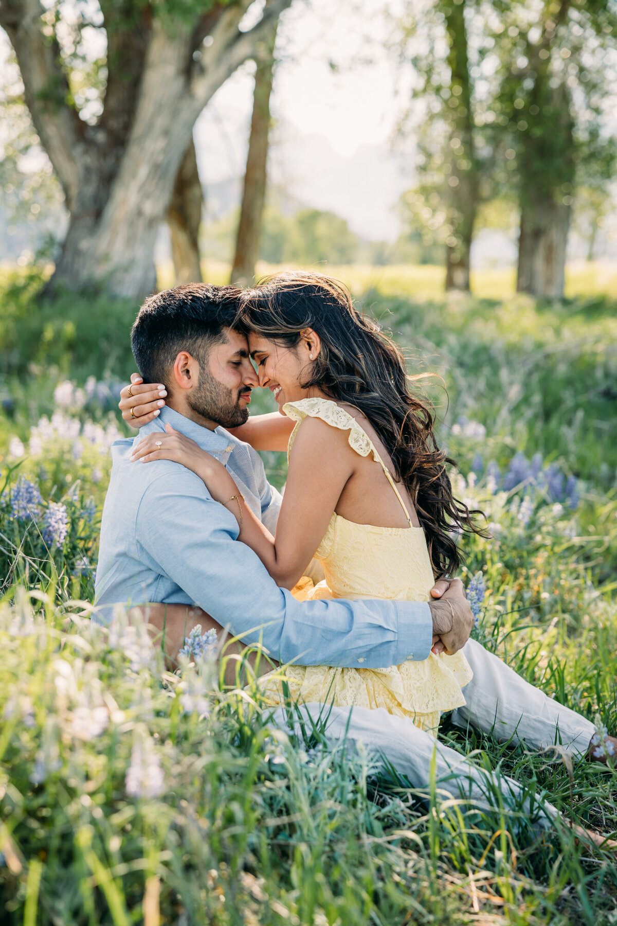 Grand Teton Wildflowers at Mormon Row with trees and couple with yellow dress in love
