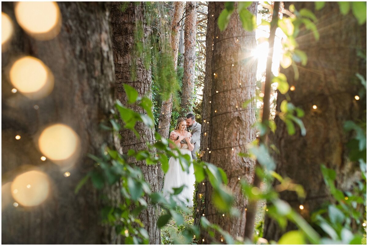 Bride and groom in the lodge pole pines at Oak Hills Reception and Event Center