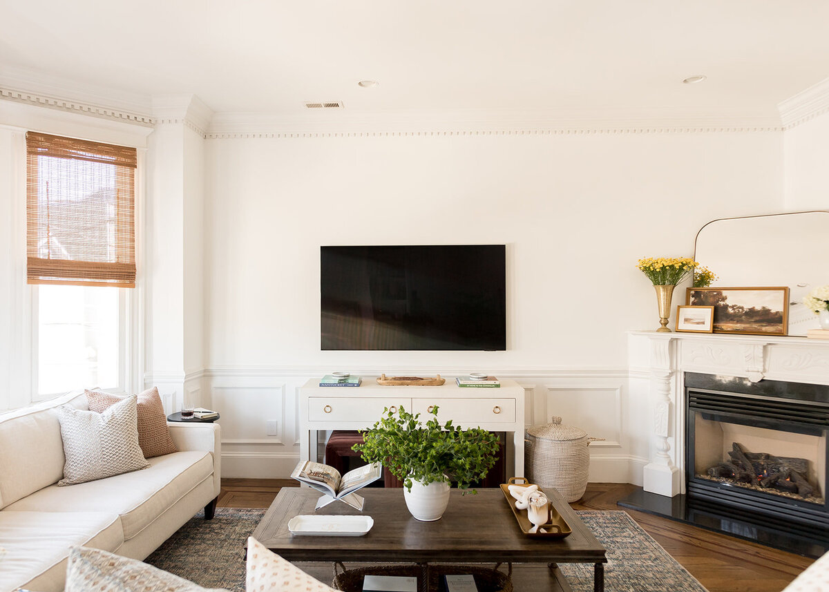 melinda chesson interiors boston living room with yellow flowers on fireplace mantle